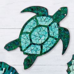 three pieces of art made out of stained glass and mosaic tiles, including a sea turtle