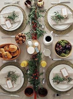 the table is set with plates, cups, and other items for an elegant meal