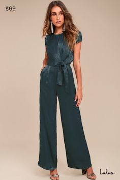 Be the perfect hostess in the Lulus Let Me Entertain You Dark Green Satin Wide-Leg Jumpsuit! Silky satin shapes a rounded neckline, cap sleeves, and a tying waist sash that creates a chic, knotted accent. Wide-leg pants with diagonal front pockets. Hidden back zipper/clasp. Fit: This garment fits true to size. Length: Floor length. Size medium measures 61" from shoulder to hem. Inseam: 31.25 Front Rise: 13.00 Bust: Great for any cup size. Waist: Fitted - very fitted at natural waist. Hip: Not Fi Reunion Outfits For Women, Formal Jumpsuits For Women Classy, Business Cocktail Attire, Officiant Attire, Homecoming Jumpsuit, Womens Dressy Jumpsuits, Semi Formal Dress Code, Wedding Guest Pants, Wedding Rehearsal Outfit