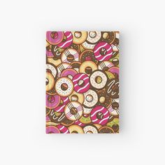 a notebook covered in donuts and sprinkles on a white background hardcover journal