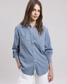 Women's cotton gabardine shirt with long sleeves and simple cuffs. Visible snap button placket. Two patch pockets. Blue Button-up Shirt With Patch Pockets, Blue Shirt With Patch Pockets And Spread Collar, Blue Classic Shirt With Patch Pockets, Classic Blue Shirt With Patch Pockets, Washed Blue Button-up Shirt With Patch Pockets, Long Sleeve Washed Blue Shirt With Button Cuffs, Washed Blue Long Sleeve Shirt With Button Cuffs, Classic Blue Shirt With Roll-up Sleeves, Classic Washed Blue Tops With Button Cuffs