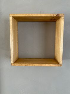 an empty wooden shelf hanging on the wall