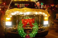 the truck is decorated with christmas lights and wreaths