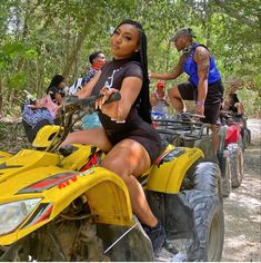 a woman riding on the back of an atv