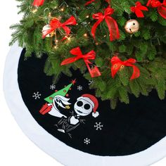 the christmas tree skirt is decorated with skulls and santa's helpers on it