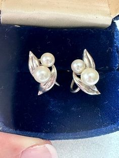 Lovely pair of genuine pearl earrings. They are set on 950 silver. The large pearls are approximately 6.75 mm and small pearls are approximately 5.75mm. The earrings are about 3/4". Excellent condition. Silver Pear-shaped Pearl Earrings For Anniversary, Vintage White Gold Pearl Earrings For Anniversary, Classic Hallmarked Pearl Earrings For Anniversary, Silver Clip-on Pearl Earrings, Providence Ri, Star Flower, Blue Rhinestones, Screw Back Earrings, Cultured Pearls