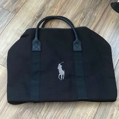 Authentic Ralph Lauren Sport Bag. Perfect Bag For Day Trip Or Even To The Gym! Size 14.5x18.5 All Black With Gray Logo And Also Have A Side Pocket. Very Spacious. Can Be Worn Over The Shoulder And Carry From Handle Black Travel Pouch Canvas Bag, Black Canvas Travel Pouch Bag, Black Canvas Pouch Bag For Shopping, Black Travel Canvas Pouch Bag, Black Top Handle Travel Bag For Shopping, Black Travel Bag With Removable Pouch For Shopping, Black Satchel Weekender Bag With Detachable Handle, Black Rectangular Weekender Bag With Detachable Handle, Black Weekender Bag For Daily Use