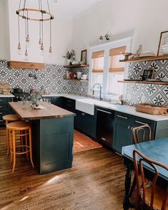 the kitchen is clean and ready to be used for cooking or baking, while the dining room table has been set up