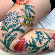 a woman's legs with flowers painted on them