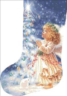 a christmas stocking with an angel standing next to a tree