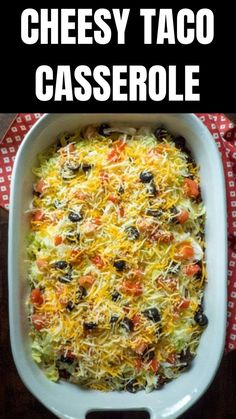 cheesy taco casserole with black olives and cheese in a white dish