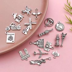 several charms are shown on a pink surface