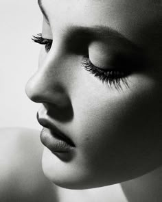 black and white photograph of a woman's face with long eyelashes