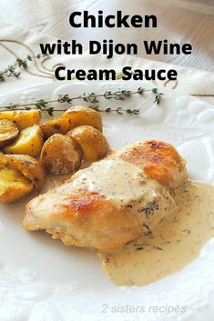 chicken with dijon wine cream sauce on a white plate