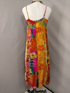 "Wonderful color and feminine styling on this vintage dress. The label is Jams World, and Falls Garden, circa nineties. Fabric content 100% rayon Made in Hawaii, USA. Fabric has a very nice feel. Shape is feminine, sleeveless, with spaghetti straps. Hem circumference is 88\". Dress length is 48\" long. Bust - armpit circumference is 37\", bodice is lined with the same fabric. Please convo me for any additional details or photos you would like. Marked size L but it is not a contemporary large Not Summer Silk Patchwork Dress, Spring Silk Dress With Patchwork, Spring Silk Patchwork Dress, Retro Multicolor Maxi Dress For Summer, Summer Multicolor Silk Midi Dress, Casual Multicolor Silk Maxi Dress, Multicolor Silk Midi Dress For Summer, Vintage Multicolor Maxi Dress For Vacation, Multicolor Vintage Maxi Dress For Vacation