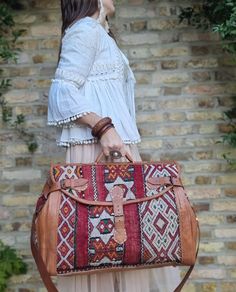 "🌟 Get ready to explore the world with our Customized Large Leather Weekender Bag for Women; a large duffle bag in boho style, handcrafted from upcycled vintage Moroccan carpet!🌟  This vintage style large leather weekender bag for women makes a unique gift for avid travellers and wanderlust girls. Combining traditional Moroccan crafts with modern elegance and practicality, this custom leather travel bag is like no other. It has been handcrafted from true vintage kilim carpets that have been up Red Travel Briefcase With Top Carry Handle, Brown Travel Bag With Top Carry Handle For Trips, Travel Bag With Detachable Handle, Brown Weekender Bag With Detachable Handle For Travel, Brown Weekender Bag With Detachable Handle, Travel Duffle Bag With Detachable Shoulder Handle, Rectangular Travel Luggage With Detachable Handle, Brown Rectangular Duffle Bag With Detachable Handle, Red Satchel Travel Bag