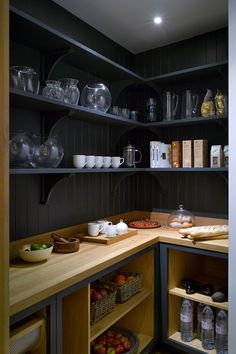 a kitchen with shelves filled with dishes and bowls