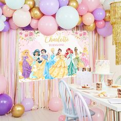 there is a birthday party with balloons and princesses on the wall in front of it