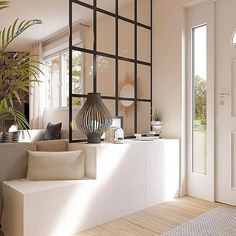 a living room filled with furniture and a large plant on top of a white shelf