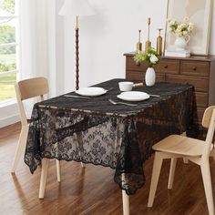 a dining room table with black lace on it