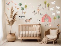 a baby's room decorated with farm animals and trees on the wall, along with a crib