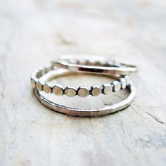 "Tiny Dots and and Hammered Stacking Rings - Set of 3 Sterling Silver Bands. I've had so many custom requests for this combination of stacking rings that I finally decided to give it its own listing! Fashioned from sterling silver, the 1.5mm-wide \"tiny dots\" stacking band is antiqued to show detail, then tumbled for strength and a high polish. Two skinny, lightly hammered, and highly polished stacking bands complete the set. See brightsmith.etsy.com for this set as part of larger stacks of mix Adjustable Stacked Midi Rings, Throne Ideas, Ring Making Ideas, Shiny Trinkets, Micro Pave Ring, Rose Gold Promise Ring, Pink Morganite Engagement Ring, Wedding Extras, Silver Bands