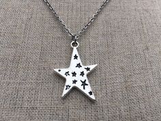 "Love this fun and whimsical silver star necklace! Made from allergy free, plated silver. It hangs from a silver plated simple 18\" chain necklace with a lobster clasp. The star measure 1\" long by 3/4\" across. I have matching earrings in my shop, if you would like the whole set. https://www.etsy.com/listing/210027881/silver-star-earrings-celestial-earrings?ref=shop_home_active_21 This is perfect for everyday, year round wear and would also make a wonderful gift. Thanks for stopping by and plea Whimsical Star Charm Jewelry As Gift, Whimsical Star Charm Jewelry Gift, Whimsical Star-shaped Jewelry With Star Charm, Silver Star Print Jewelry As Gift, Silver Star Print Jewelry For Gift, Silver Jewelry With Star Print For Gift, Silver Jewelry With Star Print As Gift, Silver Star-shaped Charm Necklace, Silver Star Shaped Charm Necklace