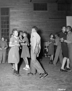 an old black and white photo of people dancing