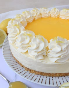 a cake with white frosting and lemons around it