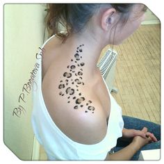 a woman with a leopard print tattoo on her shoulder