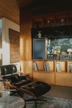 a living room filled with furniture and a flat screen tv mounted to the side of a wall