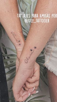 two people holding hands with tattoos on their arms and the words love are written in cursive writing