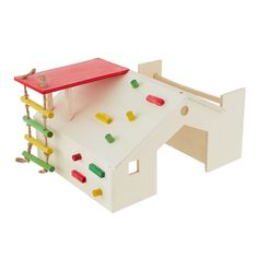 a wooden toy house with climbing bars on the roof and colorful pegs attached to it