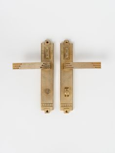 two gold door handles on a white background