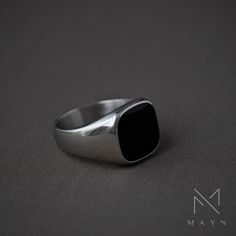 A silver signet ring with a black top is a sleek and modern take on a classic design. This elegant ring is primarily crafted from polished medical grade stainless steel, with a striking black-colored flat top. The contrast between the silver and black creates a sophisticated and bold look, making it a versatile accessory that can complement both formal and casual attire. Its minimalist yet distinctive style adds a touch of refinement to any outfit, making it a timeless and stylish choice for tho Onyx Signet Ring, Silver Signet Ring, Outfit Making, Velvet Material, Elegant Ring, Flat Color, Online Jewelry Store, Casual Attire, Flats Top