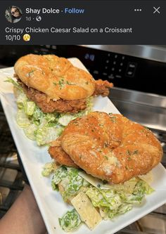 two chicken caesar salad sandwiches on a white plate