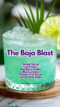 the baja blast cocktail is served in a glass with lime wedges and garnish