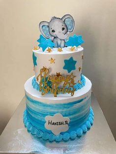 a blue and white cake with an elephant on top