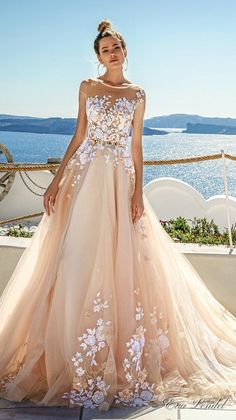 a woman in a wedding dress standing on a balcony next to the ocean and looking at the camera