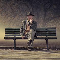 an old man sitting on a park bench