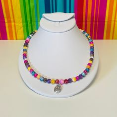 The handcrafted 21-inch multicolored rainbow necklace with a silver pendant that says "love much" on one side and "laugh often" on the other is a beautiful and thoughtful piece. The vibrant colors and positive messages make it a unique and special accessory that is sure to bring joy to the wearer. Multicolor Pendant Charm Necklace As Gift, Bohemian Multicolor Hypoallergenic Jewelry, Multicolor Heart Beads Necklace For Gift, Spiritual Rainbow Beaded Necklace As Gift, Multicolor Hypoallergenic Necklace As A Gift, Multicolor Hypoallergenic Necklace For Gift, Hypoallergenic Multicolor Necklace Perfect As Gift, Hypoallergenic Multicolor Necklace For Gift, Multicolor Round Beads Charm Necklace For Gifts