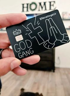 a person holding up a black card with white writing on it