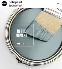 a paint can with a brush in it and the words in the moment above it