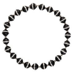 Stylish and finely detailed vintage Tiffany & Co onyx necklace, crafted in sterling silver (circa 1980s 1990s). Onyx beads are uniform in size and measure 14mm each. The stones are in very good condition and free of cracks or chips. The onyx beads, fitted with sterling silver orbs, make for a striking and unique necklace, reflective of the great design work of Paloma Picasso for Tiffany & Co. The necklace is a retired piece and no longer made by Tiffany & Co. The necklace is in very good original condition and was recently lightly cleaned and polished. Particulars: Weight: 125.2 grams Stones: Onyx beads are uniform in size and measure 14mm each. The stones are in very good condition and free of cracks or chips. Size & Measurements: The necklace measures 16 1/2 inches in length. The necklac Tiffany And Co Schlumberger Necklace, Orb Necklace, Vintage Tiffany, Paloma Picasso, Onyx Necklace, Unique Necklace, Onyx Bead, Tiffany And Co, Old Jewelry