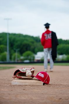 a baseball glove laying on top of a field next to a catchers mitt