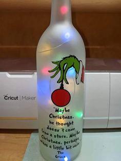 a lighted bottle with a grin face on it