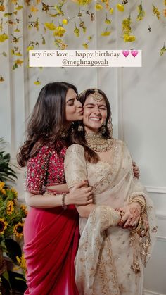 two women hugging each other in front of a flowery backdrop with the words my first love happy birthday