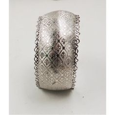 This is part of Chairish’s Costume Jewelry assortment.  1960s rhodium plated fleur de lis cuff bracelet. Marked "Jewels by Julio." Measures:  2 1/4 inches wide by 1 3/16 inches tall by 2 inches deep. Condition: Very good; some minor surface wear towards the back and to the signature. Harder to see in person than in the photos. Vintage Silver Cuff Bangle, Formal Antique Silver Engraved Cuff Bracelet, Formal Engraved Antique Silver Cuff Bracelet, Engraved Antique Silver Cuff Bracelet For Formal Occasions, Silver Cuff Bangle In Vintage Style, Silver Wide Band Bangle For Formal Occasions, Formal Silver Bangle With Wide Band, Silver Bangle Cuff Bracelet For Formal Occasions, Formal Etched Silver Cuff Bracelet