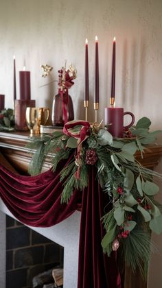 a christmas mantle with candles and greenery