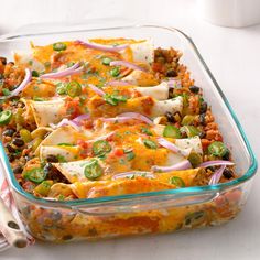 a glass casserole dish filled with mexican food